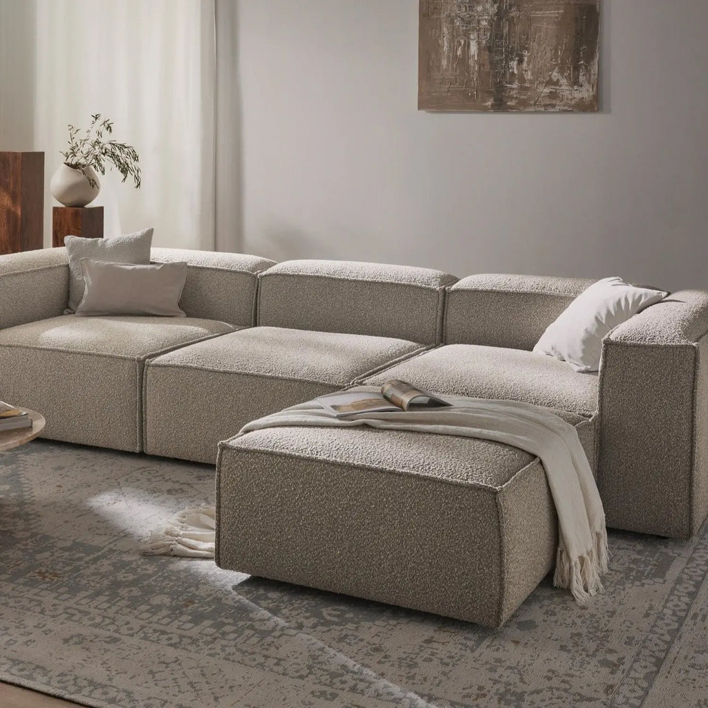 Canapé modulable 4 places en tissu bouclé avec pouf