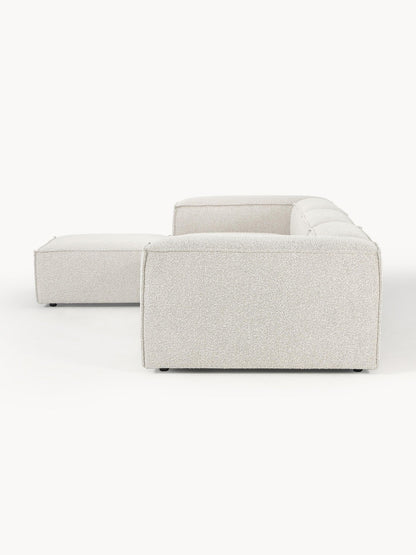 Canapé modulable 4 places en tissu bouclé avec pouf