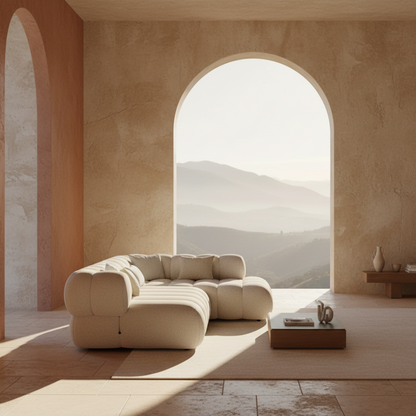 Canapé d'angle gauche MARBEA en bouclette écru vu de profil, pièce terracotta avec fenêtre arquée et vue montagne – Maroc Design