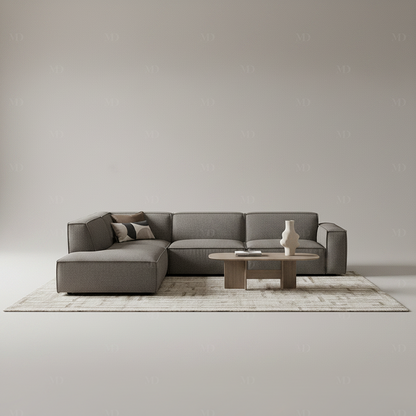 Canapé d'angle modulable BOXTER 7 places en bouclette gris anthracite, en situation dans un salon avec table basse – Maroc Design